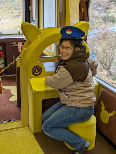 QC on the Pokemon With You train, wearing a train conductor's hat