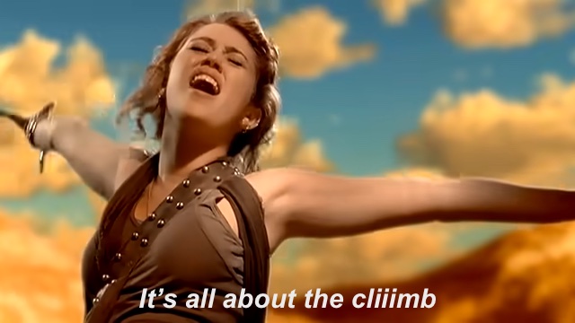 A frame showing
  Miley Cyrus in the music video for The Climb